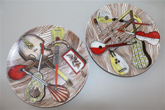 A large Fornasetti Strumenti Musicali pattern dish and four similar plates, 20.5.cm - 32cm